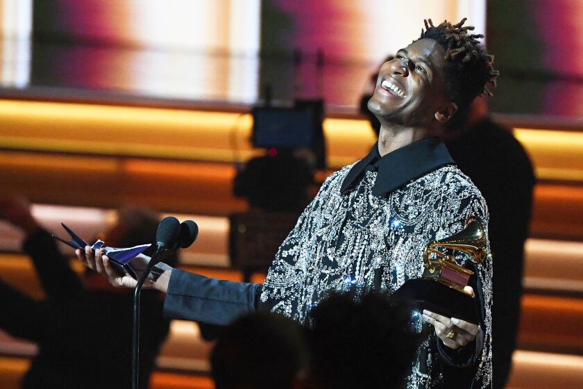 US singer Jon Batiste celebrates after winning the Album of the Year at the Annual Grammy Awards 