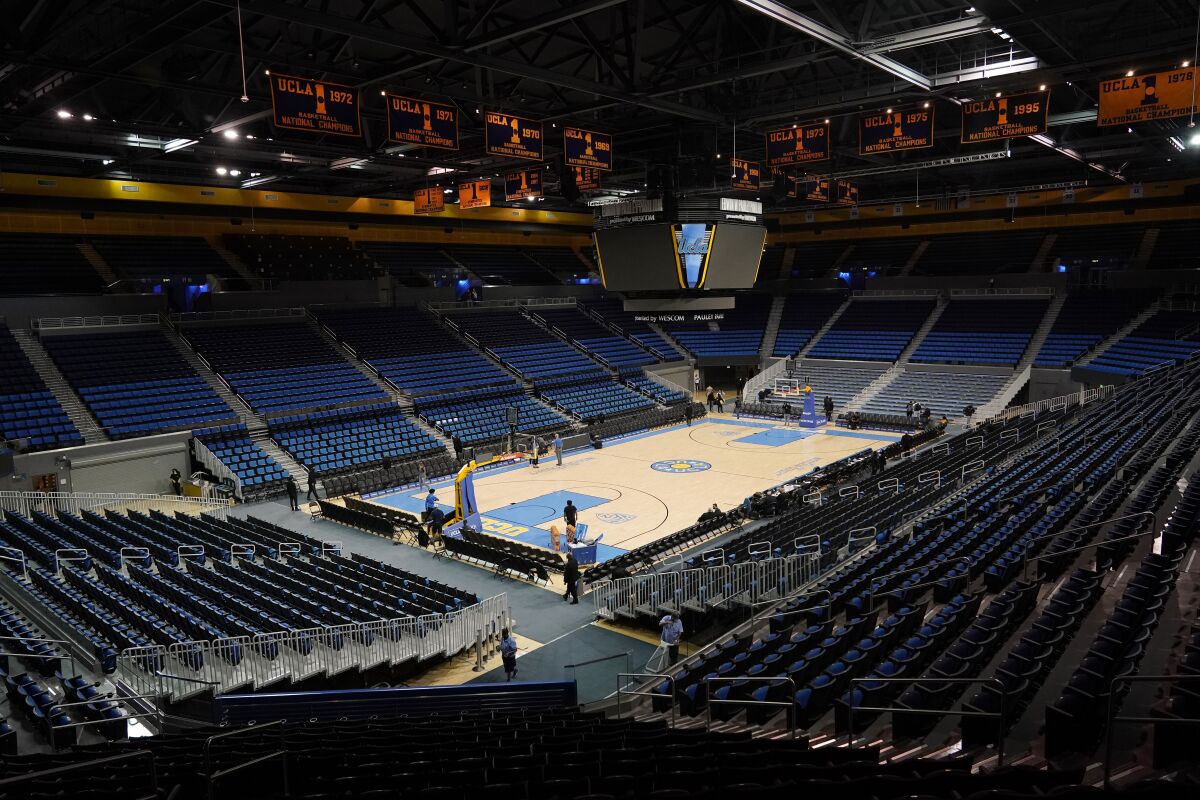 An empty Pauley Pavilion is seen before an NCAA college basketball game between UCLA and Alabama State Wednesday, Dec. 15, 2021, in Los Angeles. The game will not be played due to COVID-19 protocols. (AP Photo/Marcio Jose Sanchez)
