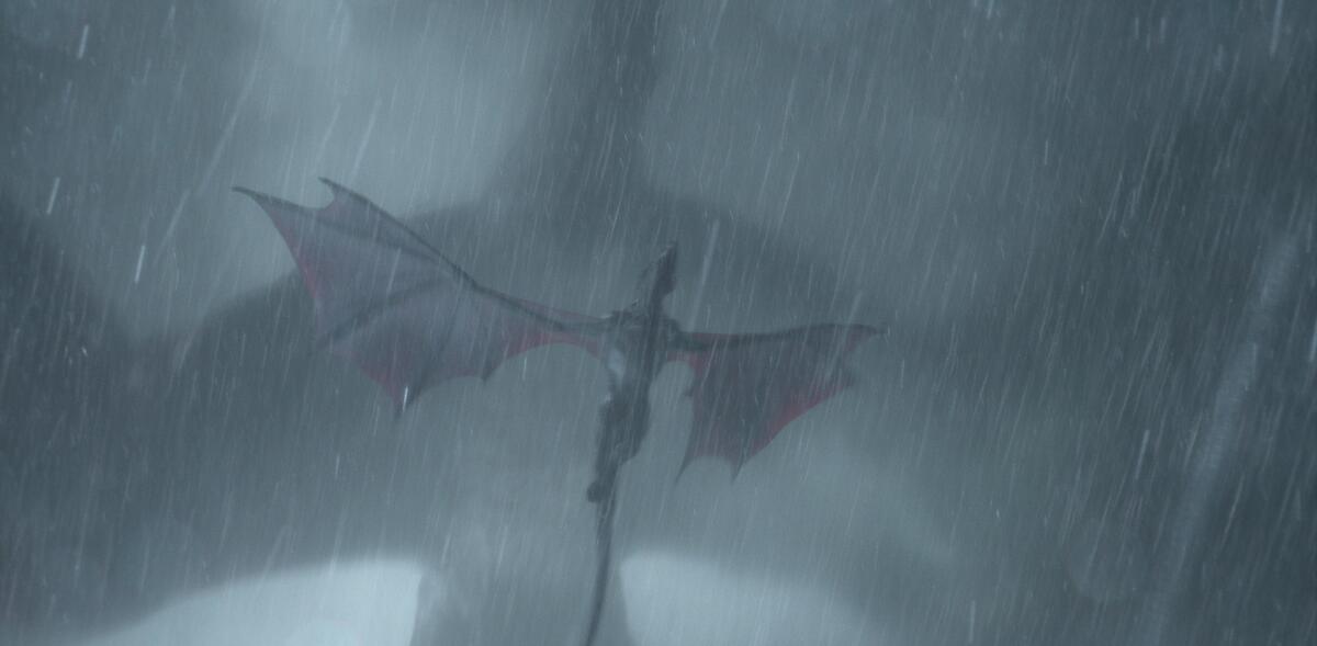 In driving wind and rain, a giant dragon passes above the much smaller one it's about to attack in "House of the Dragon."