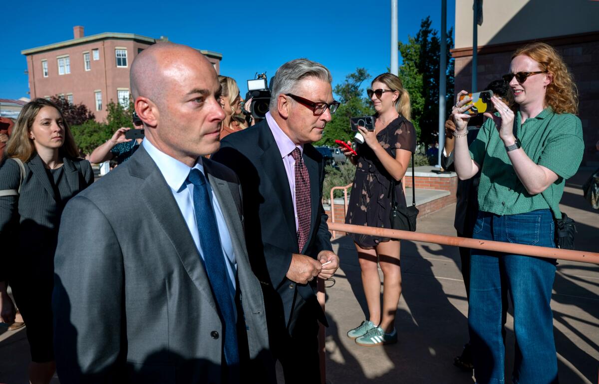 Actor and producer Alec Baldwin, center, enters First District Court 