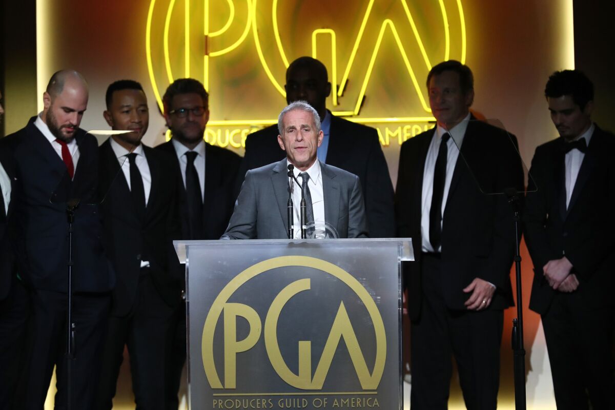 Marc Platt, with the cast and crew of "La La Land," accepts the award for theatrical motion picture at the Producers Guild Awards.