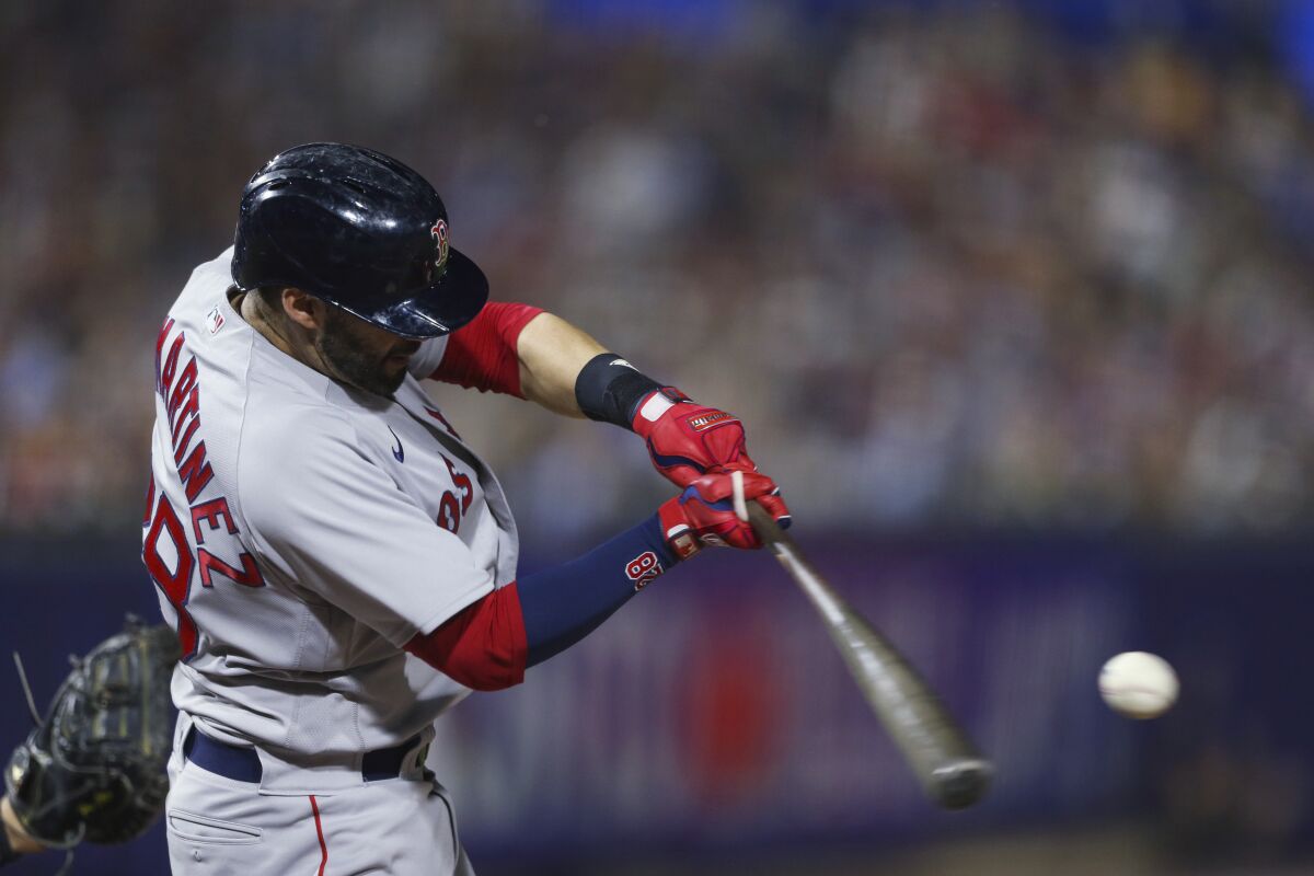 Boston Red Sox's J.D. Martinez hits a home run during the eighth inning of the team's baseball game against the Boston Red Sox on Wednesday, July 21, 2021, in Buffalo, N.Y. (AP Photo/Joshua Bessex)