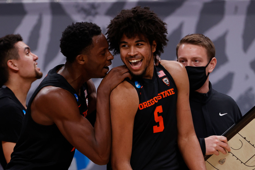 INDIANAPOLIS, INDIANA - MARCH 27: Ethan Thompson #5 of the Oregon State Beavers celebrates with Warith Alatishe.