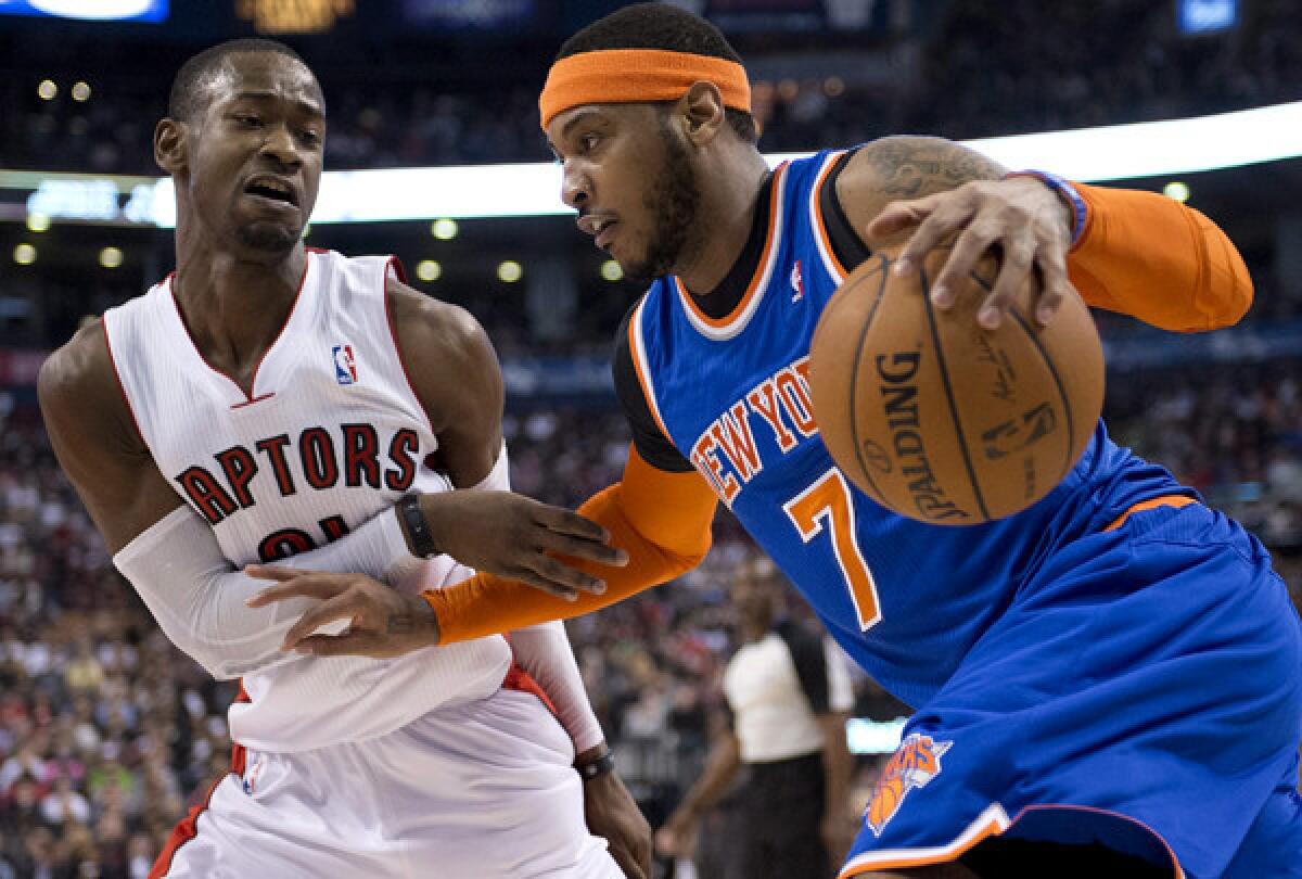 Knicks forward Carmelo Anthony drives against Raptors guard Terrence Ross during a game last week in Toronto.