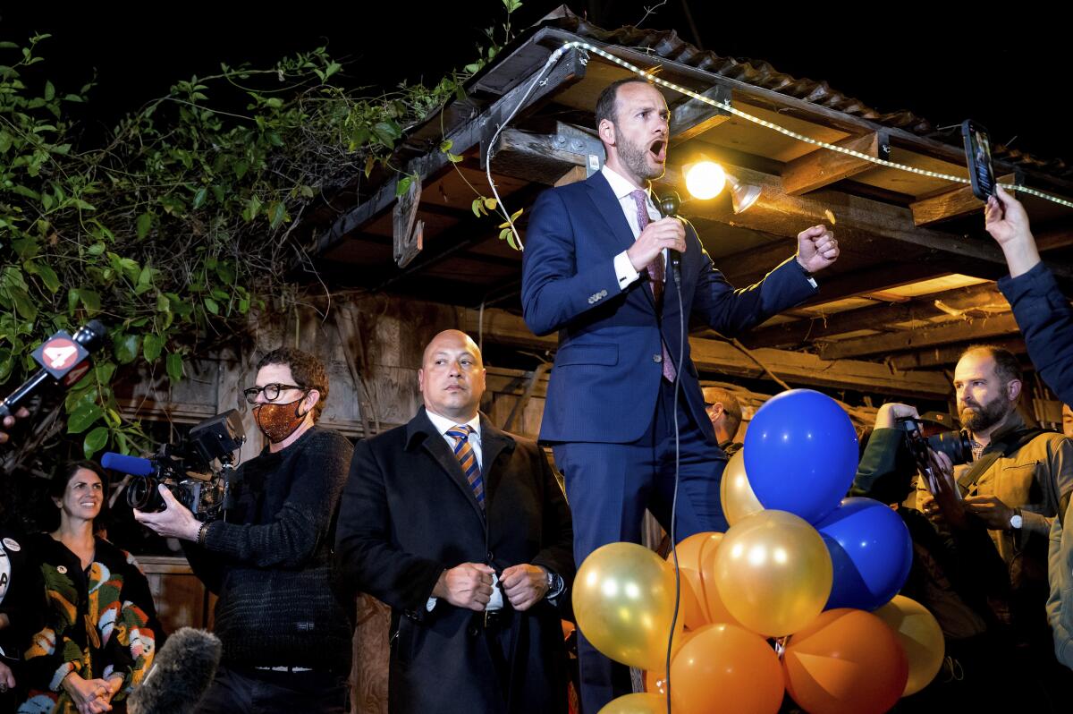 San Francisco Dist. Atty. Chesa Boudin addresses supporters at night.