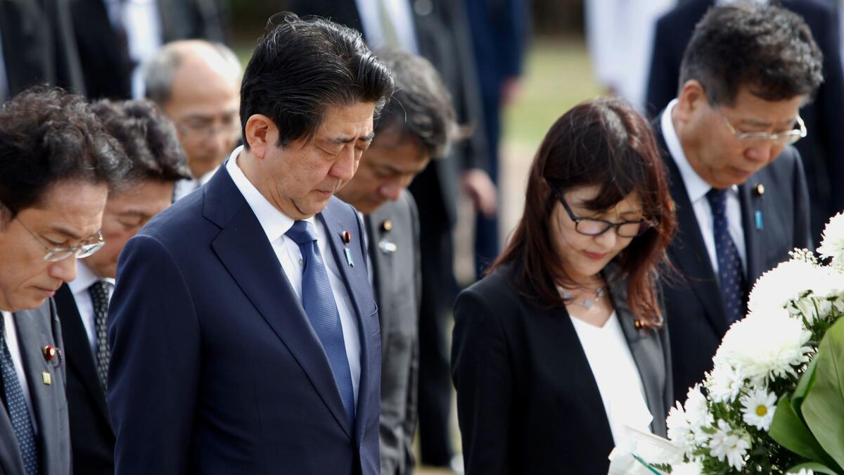Japanese Prime Minister Shinzo Abe, second from left, at the Ehime Maru Memorial at Kakaako Waterfront Park on Monday in Honolulu.
