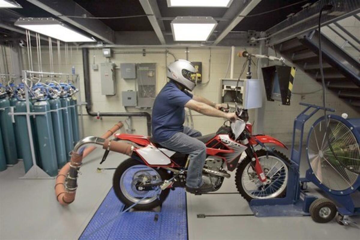 Tom Santos, 56, uses a Dynamometer to simulate the emission test of a Gas Gas FSR 450 motorcycle at California Air Resources Board facility in El Monte.