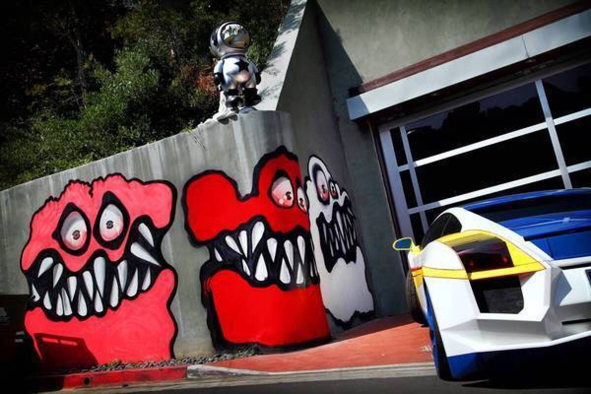 Colorful and toothy faces adorn a retaining wall at entertainer Chris Brown's Hollywood Hills house. Residents have complained, but his lawyer says it's a 1st Amendment issue.