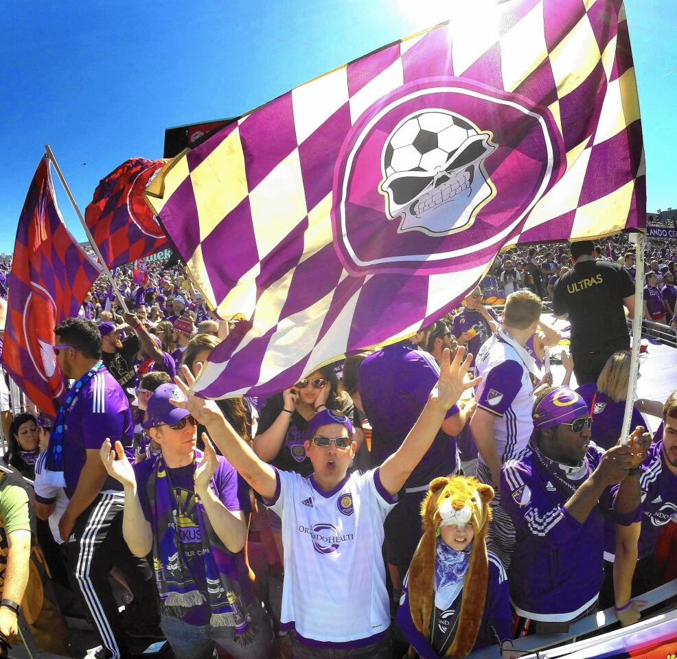 Members of the Ruckus fan club cheer in the south end zone at the Citrus Bowl before kick-off of the season opener for the Orlando City Soccer Lions, Sunday, March 6, 2016.
