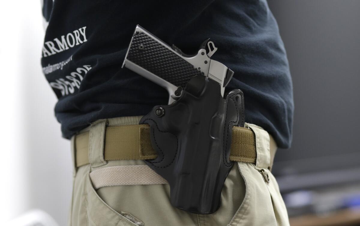 An instructor has a Ruger hand gun holstered while teaching a concealed carry permit class in Florida on Jan. 5.