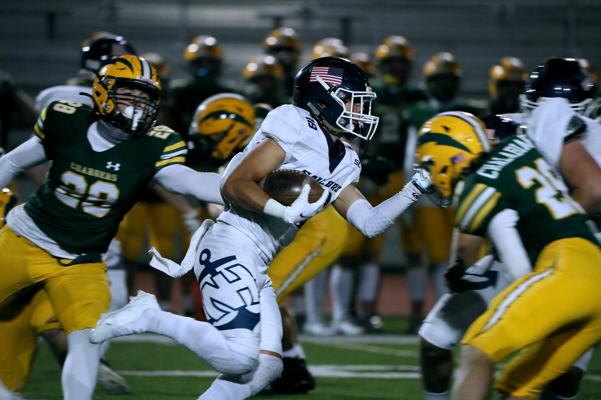 Newport Harbor's Josiah Lamarque runs the ball against Edison.