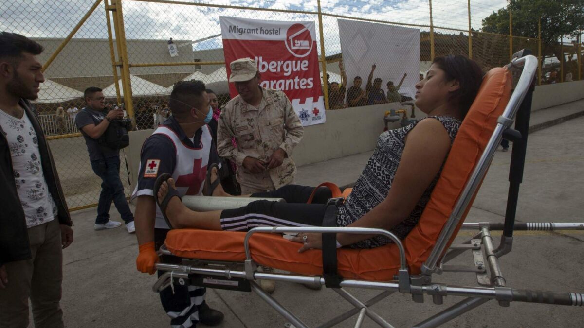 Red Cross paramedics transport a Honduran woman to the hospital after she had an asthma attack in the U.S. border city of Piedras Negras, state of Coahuila, Mexico on Feb. 6.