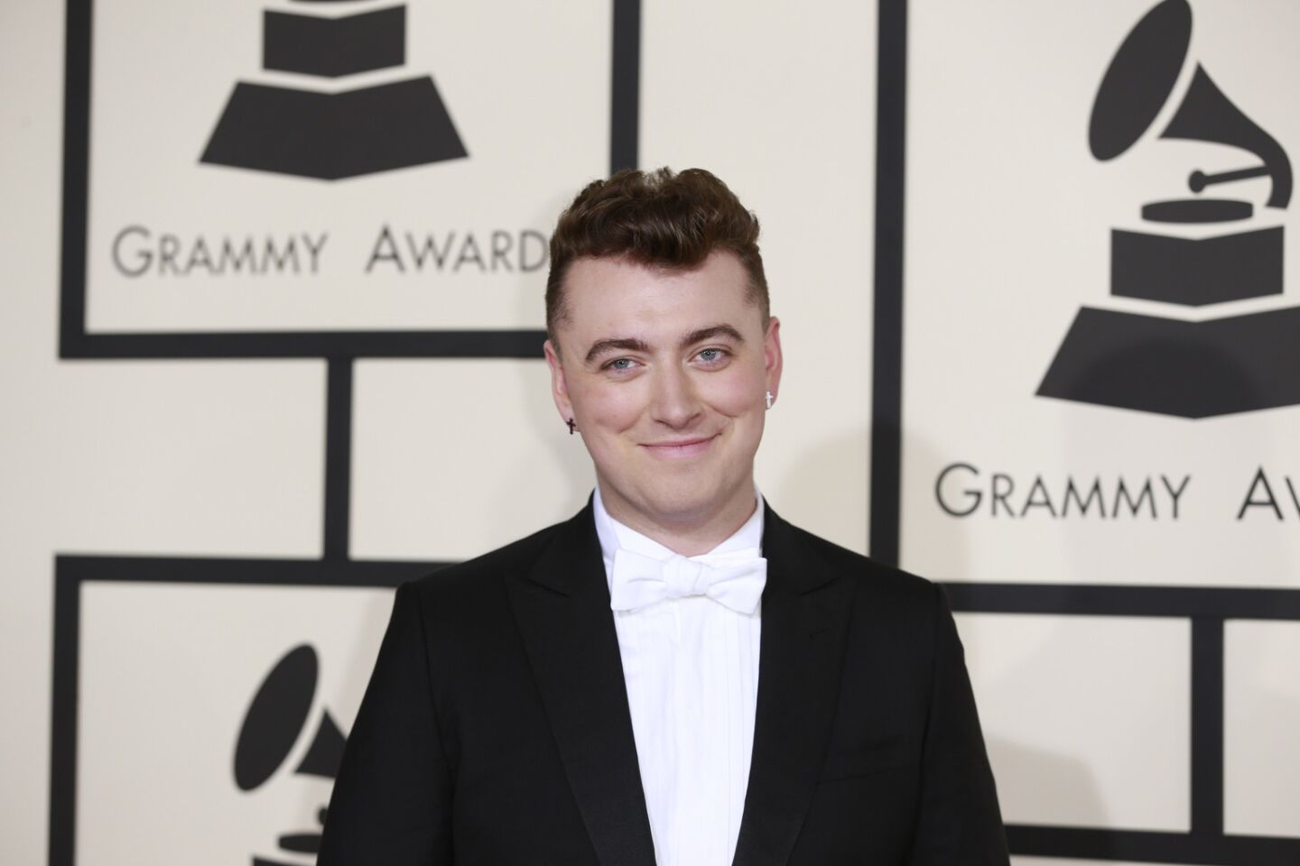 Multiple-nominated Sam Smith smiles on the red carpet.