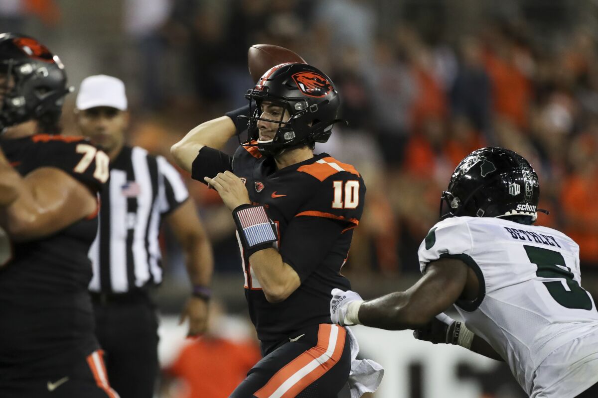 Oregon State quarterback Chance Nolan (10) throws a 13-yard pass to Oregon State wide receiver Anthony Gould (15) for a touchdown during the second half of an NCAA college football game against Hawaii, Saturday, Sept. 11, 2021, in Corvallis, Ore. Oregon State won 45-27. (AP Photo/Amanda Loman)