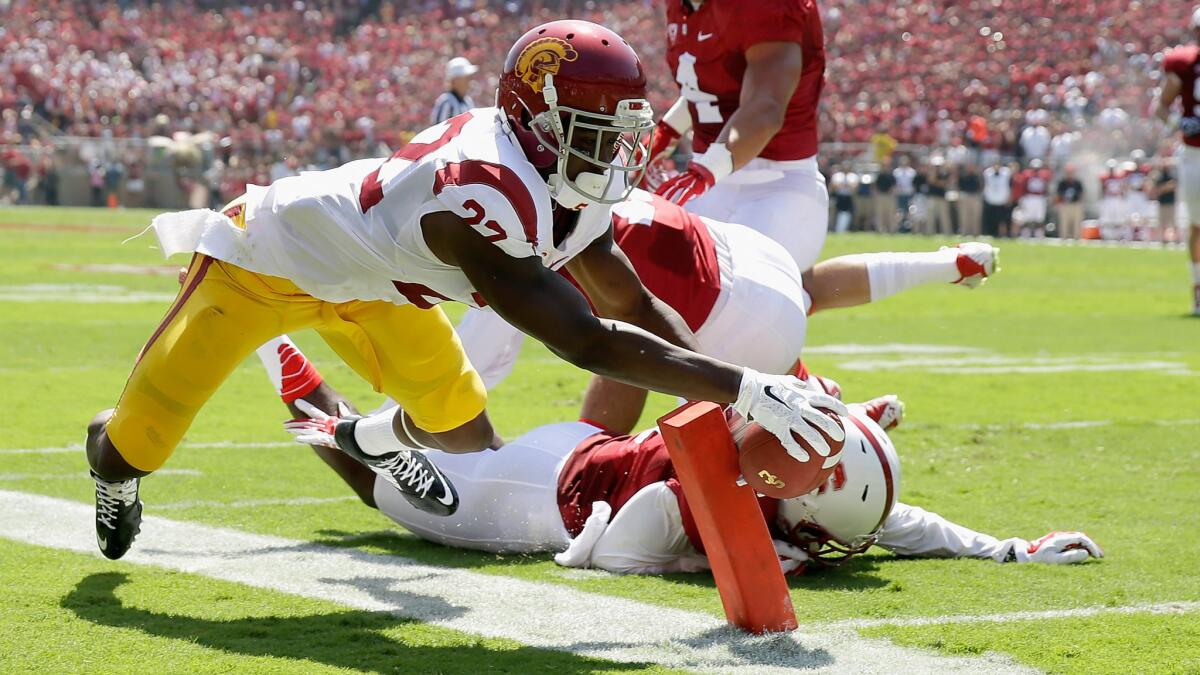 USC running back Justin Davis dives just short of the end zone as he's pushed out of bounds by Stanford's Jordan Richards during the first quarter of the schools' Sept. 6, 2014, matchup. Davis scored on the next play.