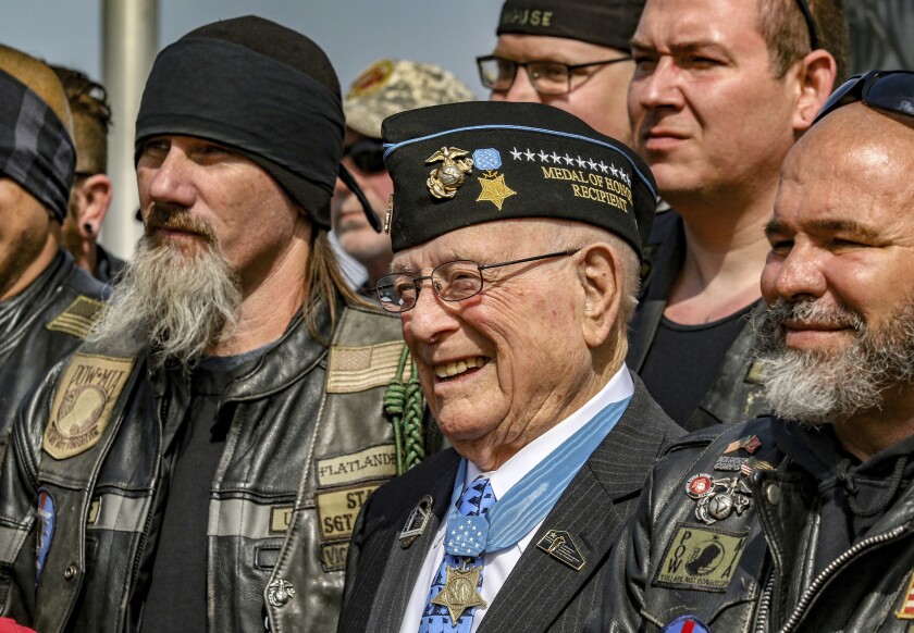 FILE - Hershel "Woody" Williams, center, the sole surviving U.S. Marine to be awarded the Medal of Honor during World War II, poses with fellow Marines at the Charles E. Shelton Freedom Memorial at Smothers Park, Saturday, April 6, 2019, in Owensboro, Ky. Williams, the last remaining Medal of Honor recipient from World War II, died Wednesday, June 29, 2022 He was 98. Williams' foundation announced on Twitter and Facebook that he died at the Veterans Affairs medical center bearing his name in Huntington. (Greg Eans/The Messenger-Inquirer via AP, File )