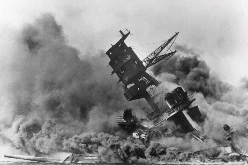 FILE - In this Dec. 7, 1941 file photo, smoke rises from the battleship USS Arizona as it sinks during a Japanese surprise attack on Pearl Harbor, Hawaii. The coronavirus pandemic is preventing Pearl Harbor survivors from attending an annual ceremony to remember those killed in the 1941 attack. The National Park Service and Navy also are closing the ceremony to the public and livestreaming it instead. (AP Photo, File)