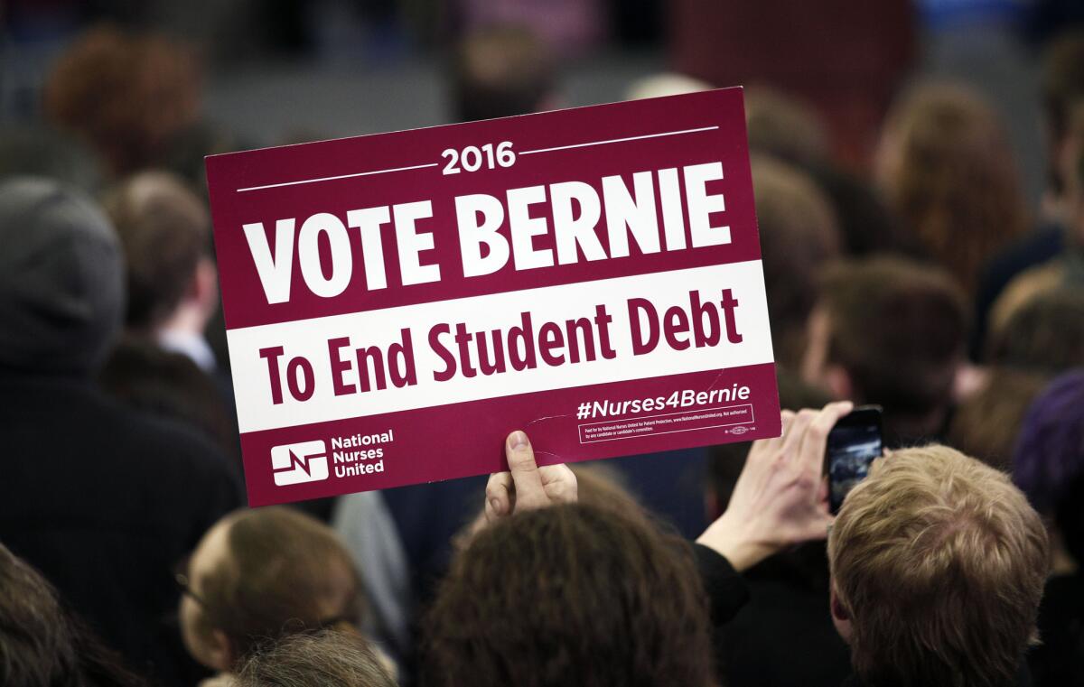 A supporter of Democratic presidential candidate Bernie Sanders holds a sign at Sanders' first campaign rally in Michigan.