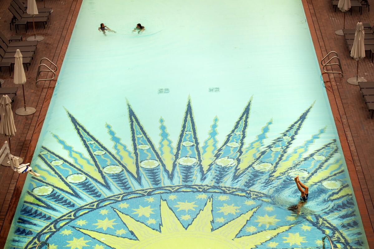 Guests swim in a pool with a sunburst design at the Montage Laguna Beach.