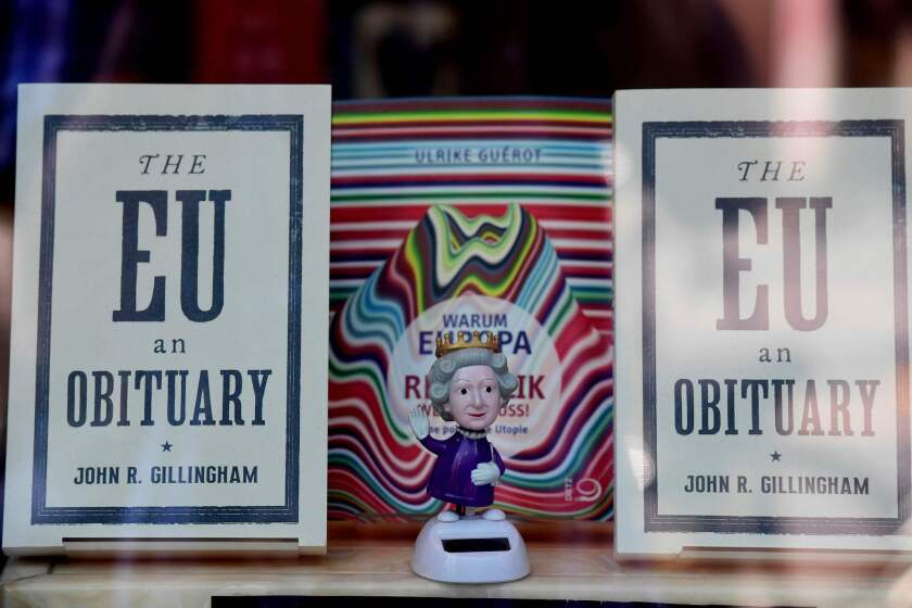 A figurine depicting Britain's queen Elizabeth II on display with copies of "The EU: An Obituary" by John R. Gillingham in a book shop window in Berlin.