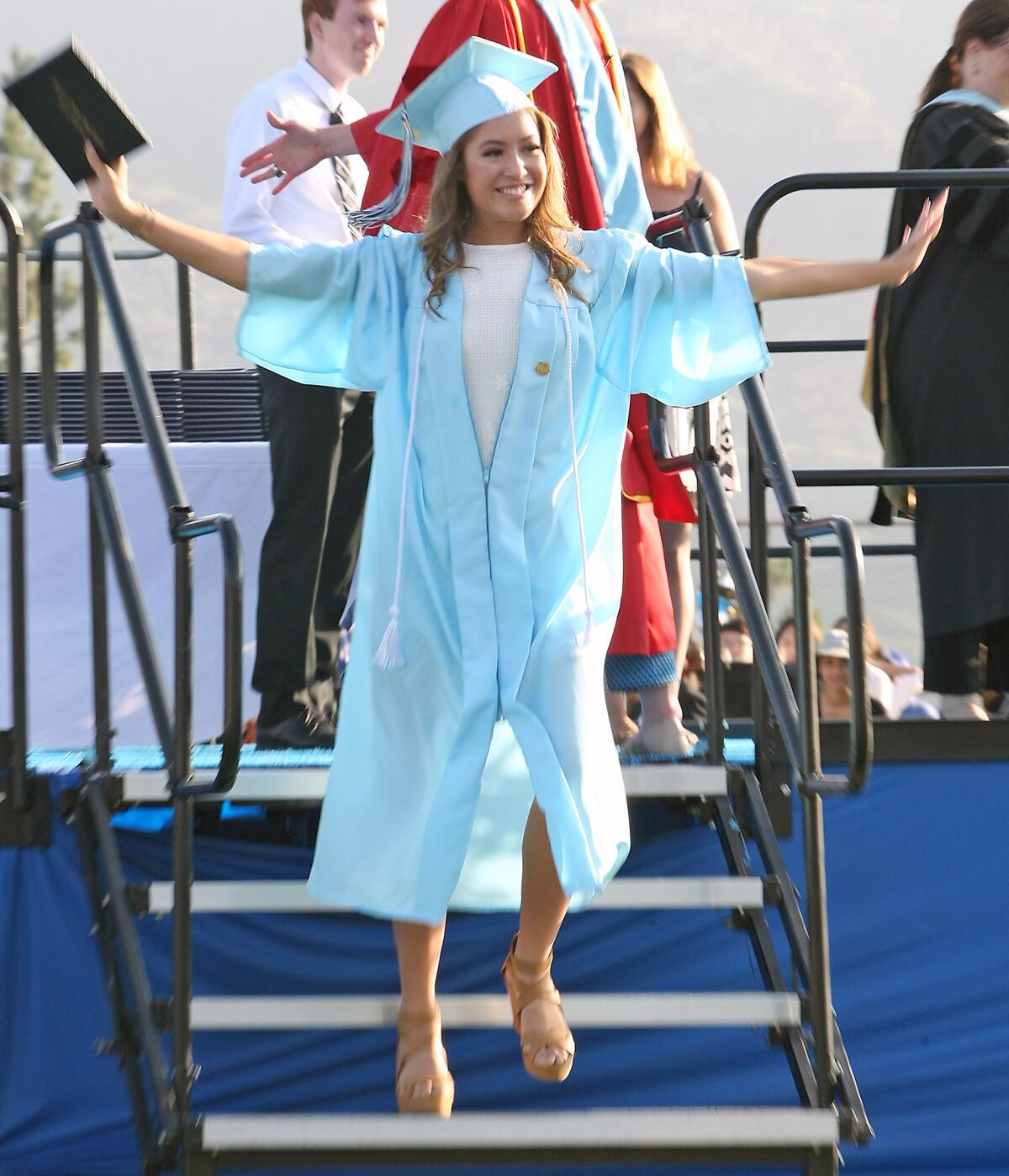 Xiamara Velasco Mayner flies off the stage after receiving her diploma during the Crescenta Valley High School graduation ceremony on Wednesday, June 1, 2016.