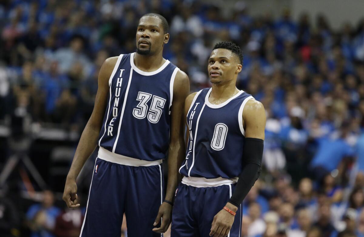 Thunder forward Kevin Durant (35) and guard Russell Westbrook (0) watch a free throw during the first half in Game 3 of their first-round series against the Mavericks on Apr. 21.