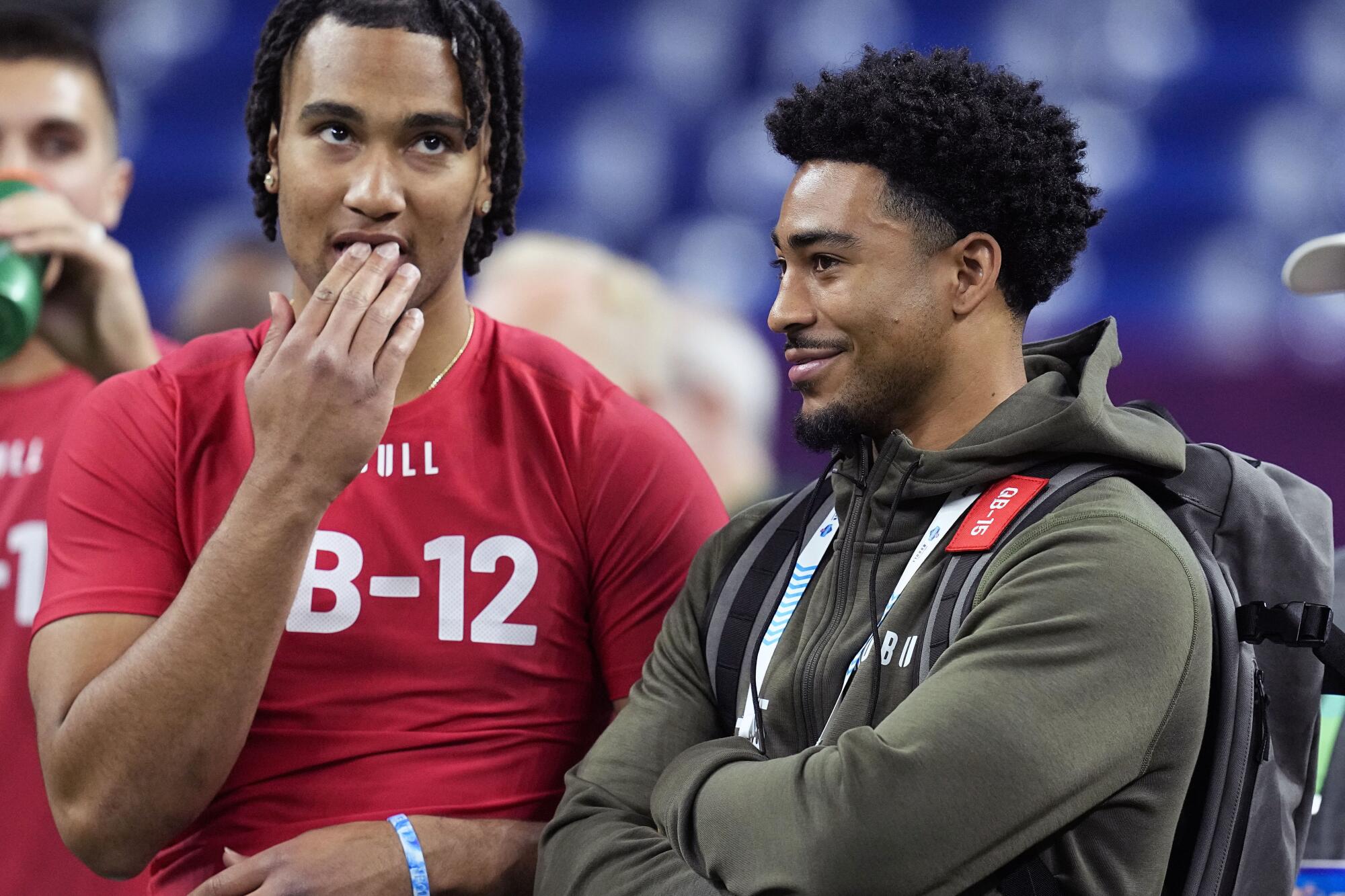 Ohio State quarterback CJ Stroud talks to Alabama quarterback Bryce Young at the NFL scouting combine in Indianapolis.