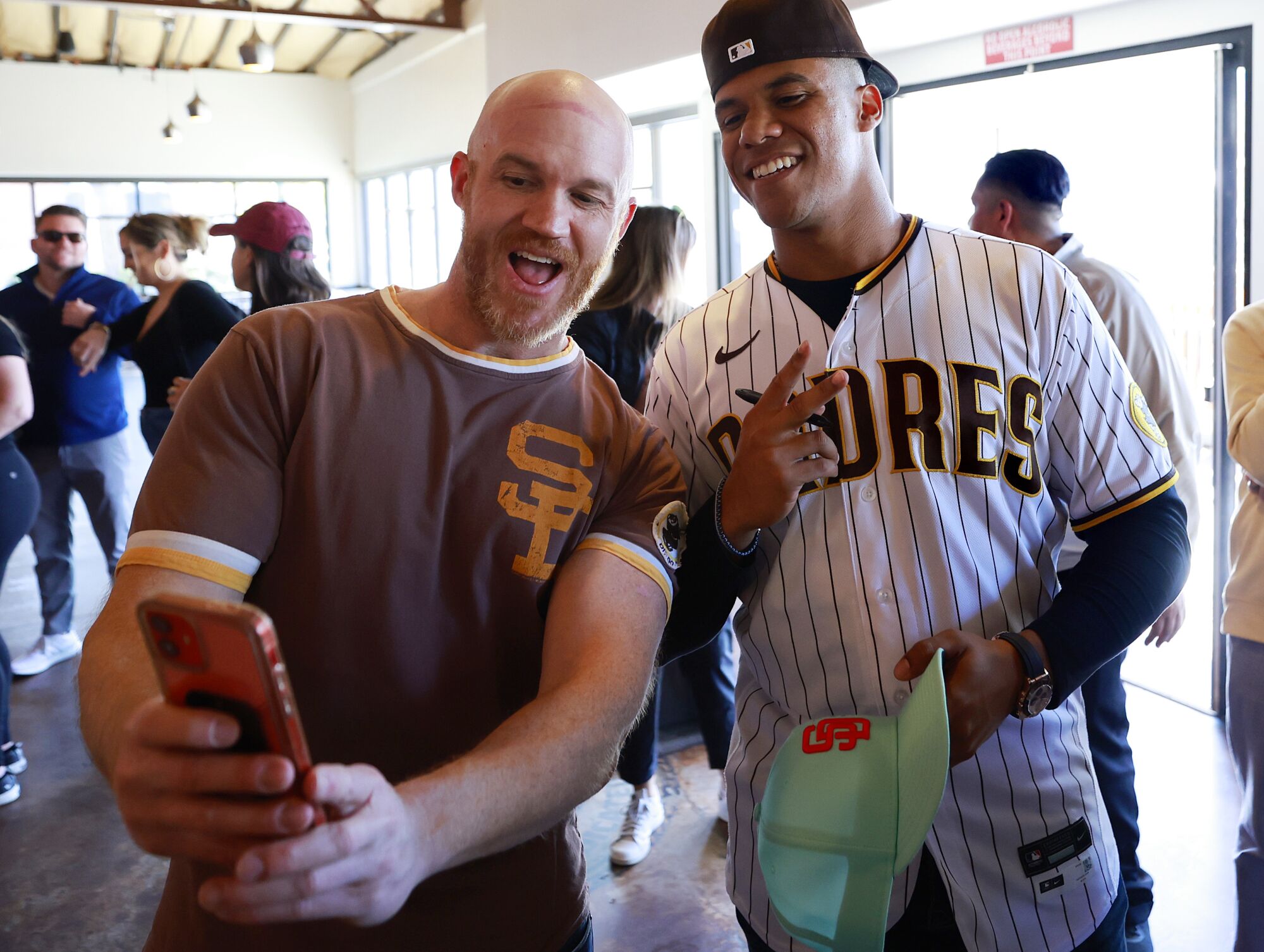 Padres Juan Soto takes a photo with fan Jon Burris at Ballast Point Brewing.