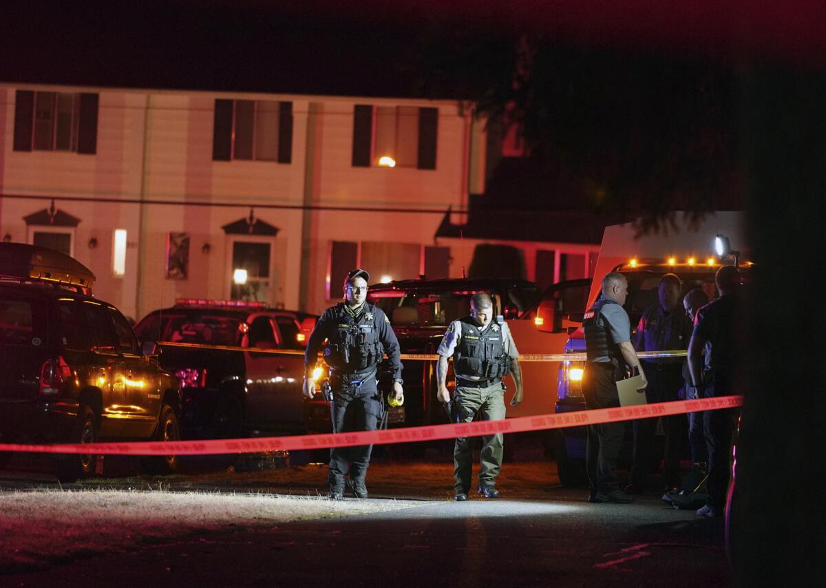 Police officials at the the scene where the suspect was killed.