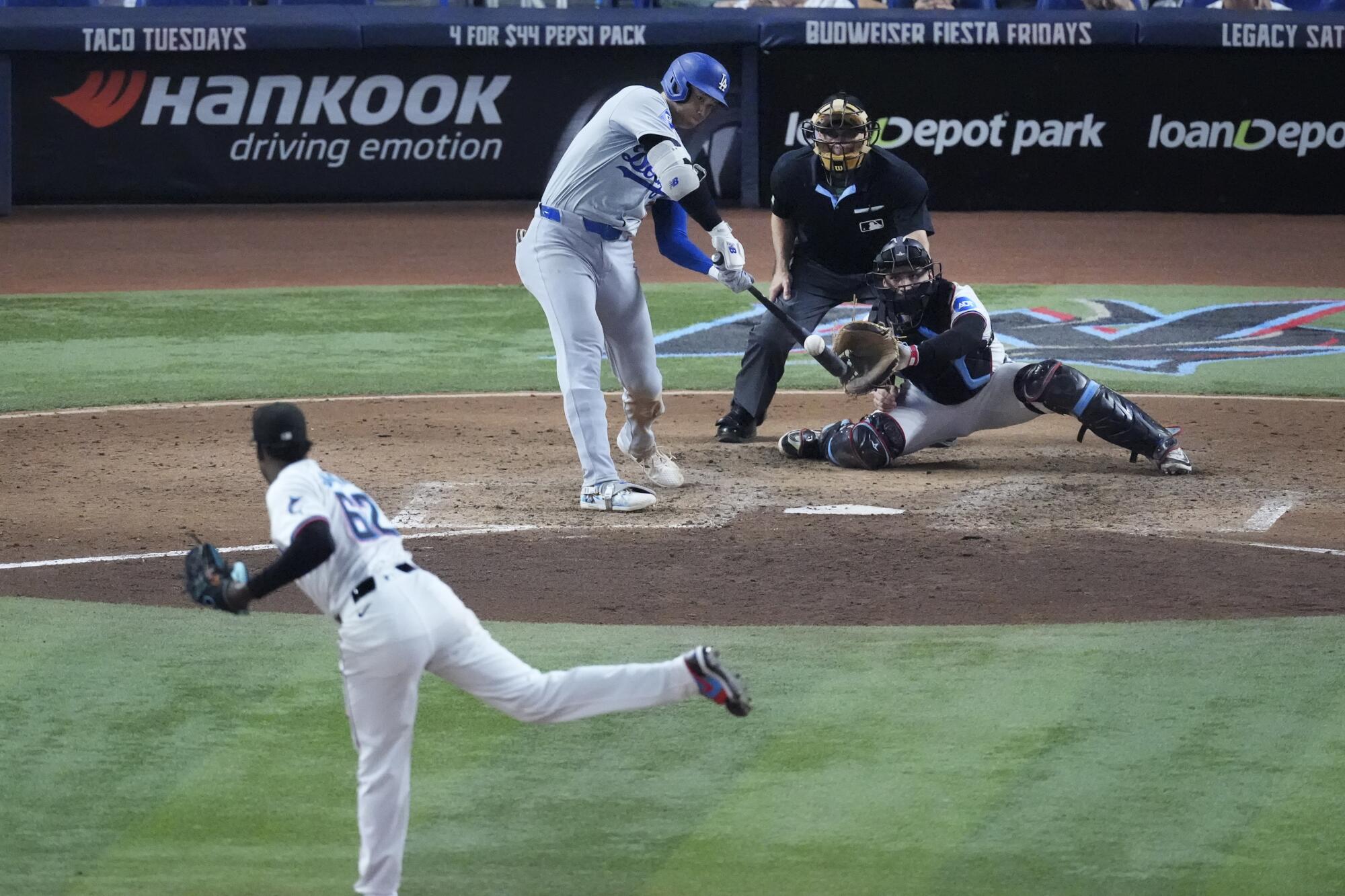 Shohei Ohtani hits his 49th home run, a two-run shot off Marlins pitcher George Soriano during the sixth inning Thursday.