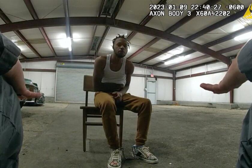 In this image from Baton Rouge Police Department body camera video, officers interact with Jeremy Lee inside a warehouse in Baton Rouge on Jan. 9, 2023. Lee sued the department in August 2023 alleging officers abused him in the police warehouse nicknamed the “Brave Cave.” (Baton Rouge Police Department via AP)