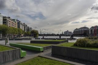 Commuters pass through the 'Silicon Docks' area in central Dublin.