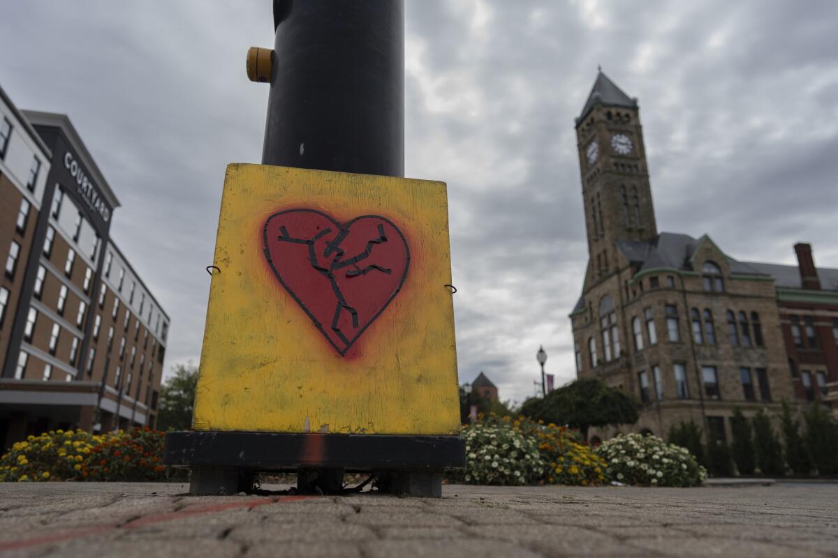 An image of a broken heart, affixed across the street from City Hall, captures the mood for many rin Springfield, Ohio.