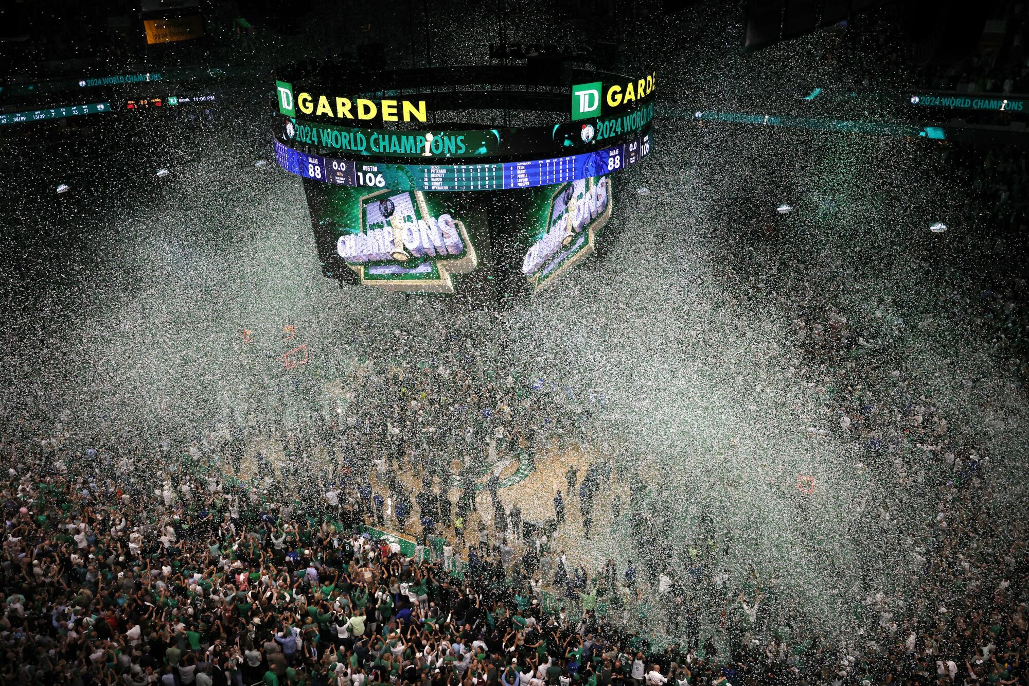 Fans and players celebrate at TD Garden in Boston after the Celtics' NBA championship win.