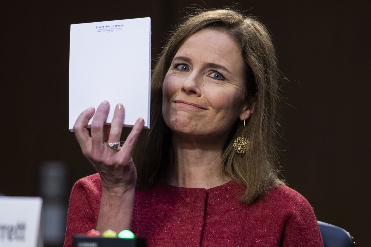 Supreme Court nominee Amy Coney Barrett holds up her notepad as she speaks on the second day of her confirmation hearing.