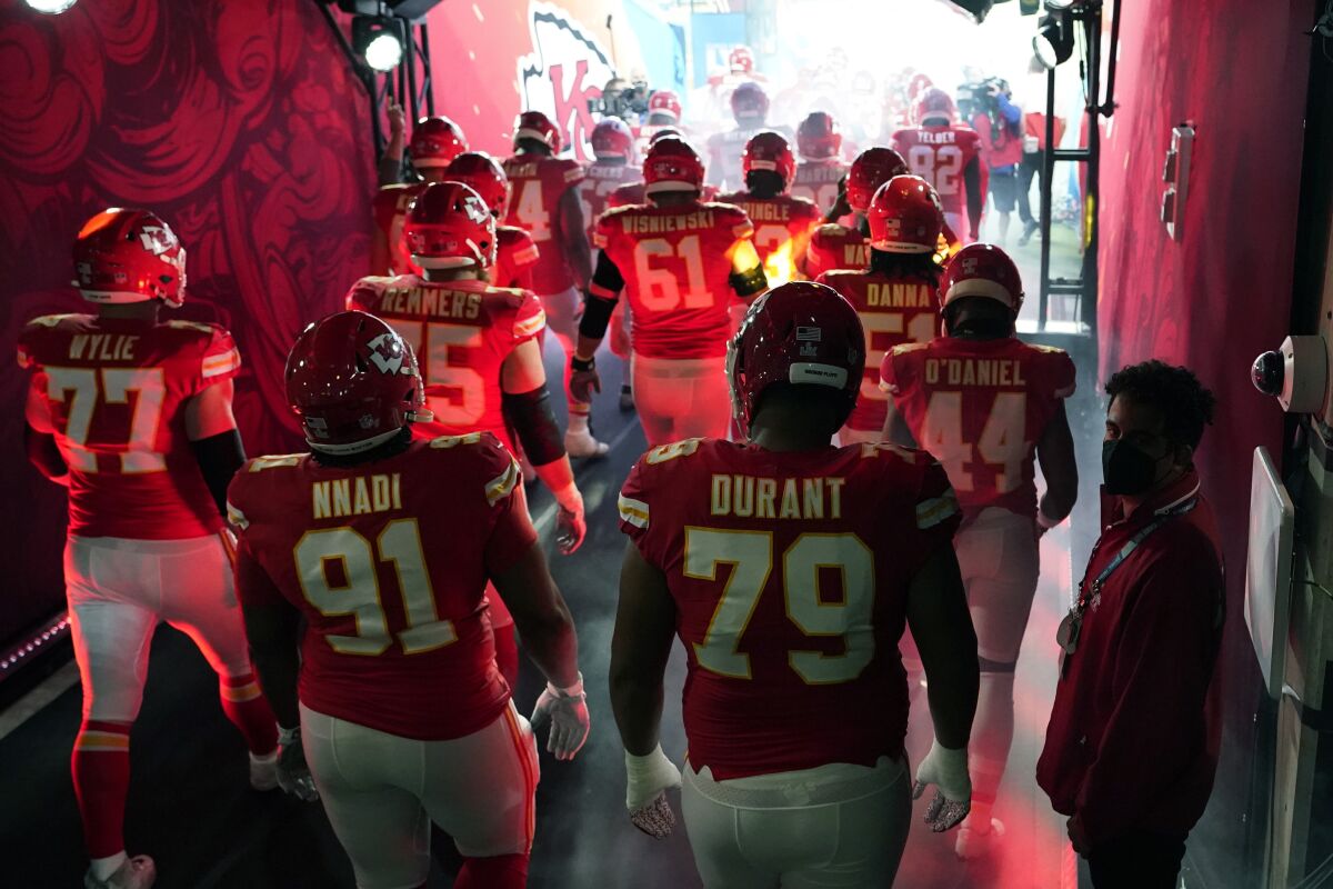 The Kansas City Chiefs run onto the field before the start of Super Bowl LV.