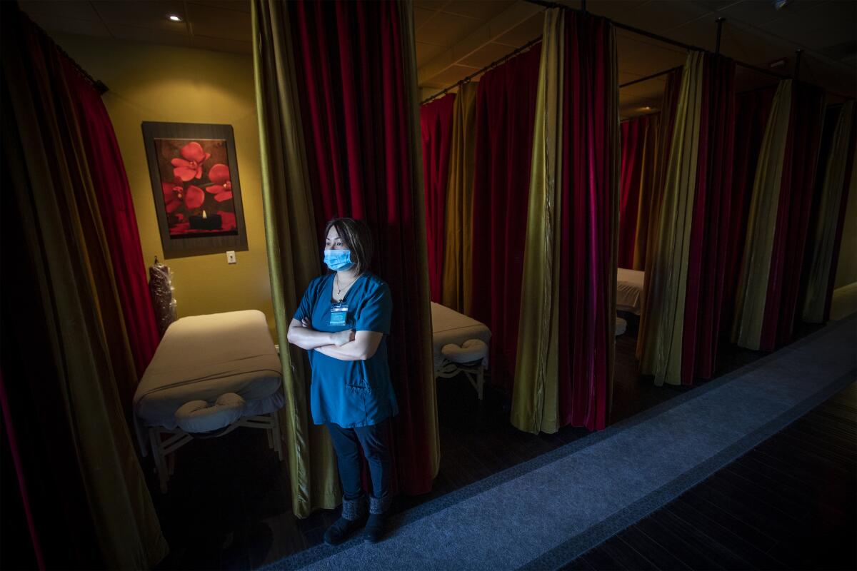 Store manager Demi Quynh looks out the window from her health spa