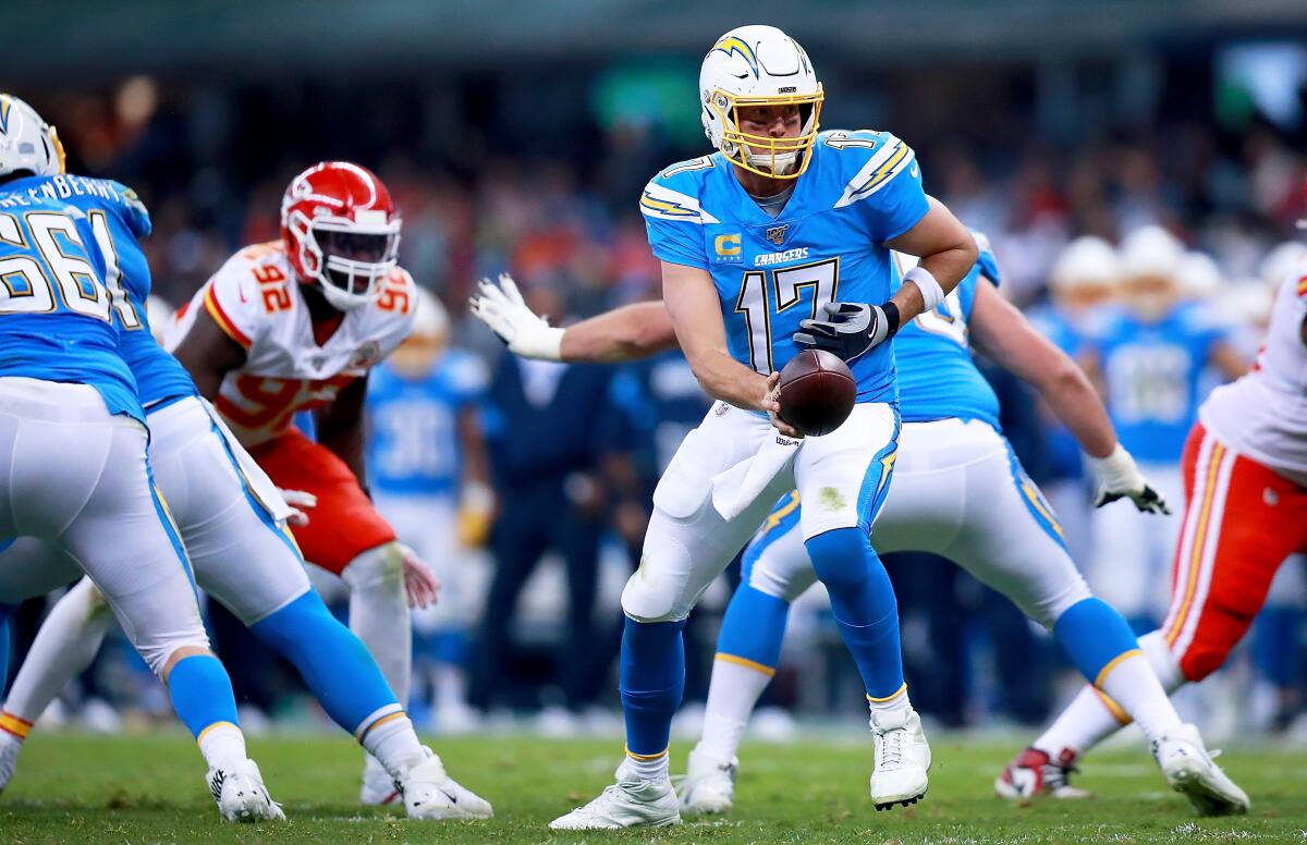 Chargers quarterback Philip Rivers hands off the ball against the Chiefs.