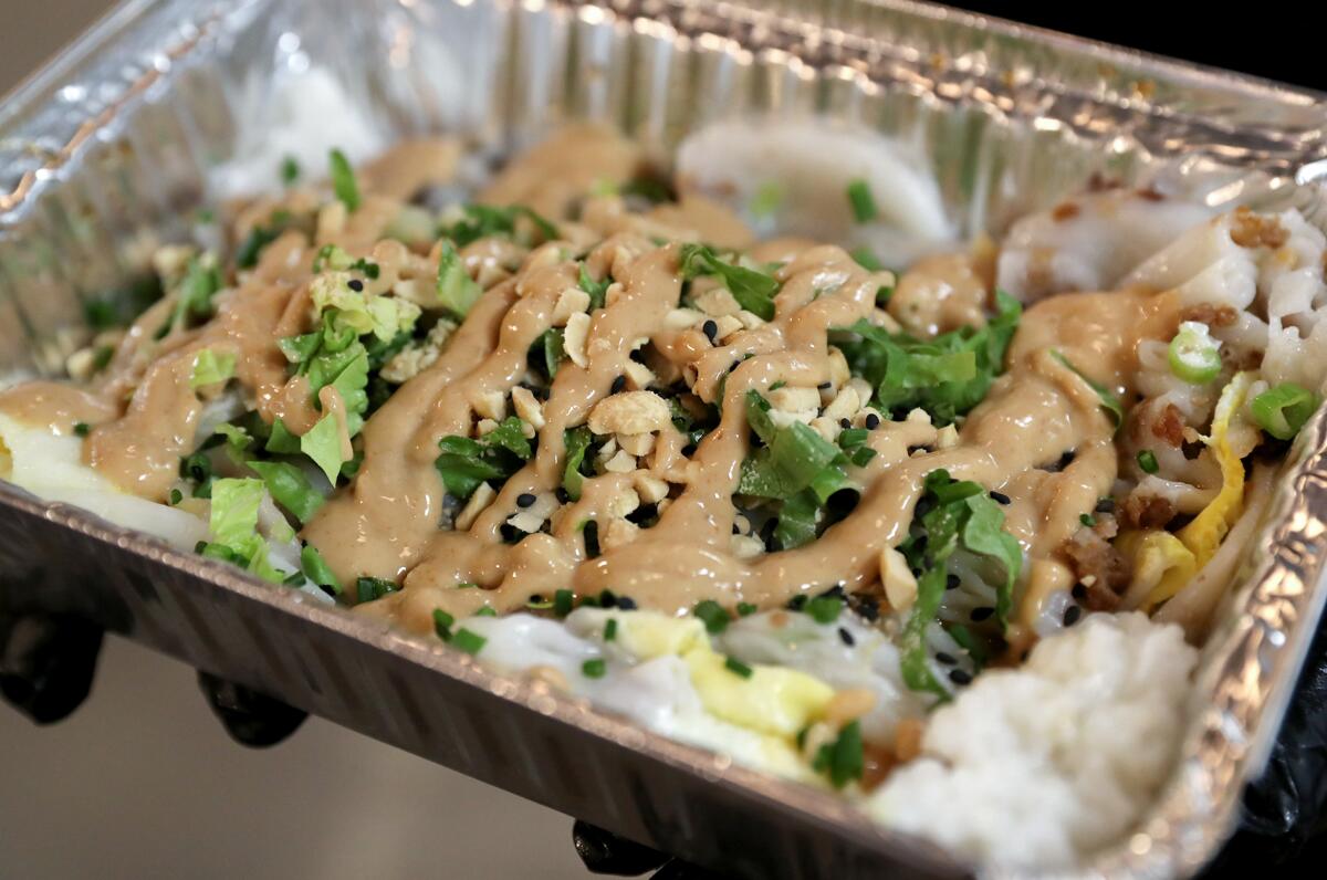 A steamed rice roll with caramelized pork, romaine, peanut sauce and thai basil at the Mo Mi Mei restaurant in Costa Mesa.