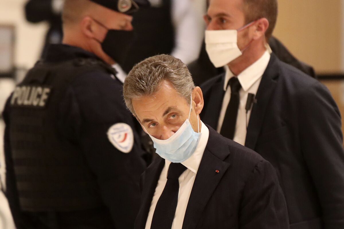 Former French President Nicolas Sarkozy arrives at a Paris court Monday for his corruption trial.