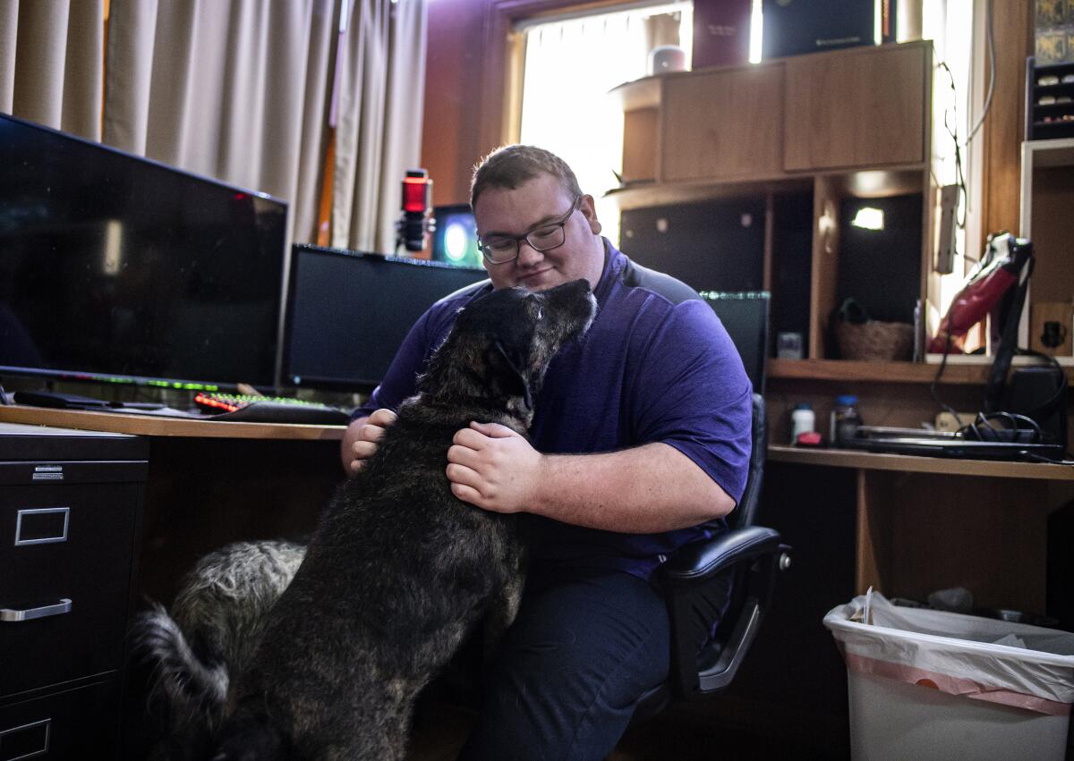 Laurens van Beek, with his dog Mocha, at his family's home in Iowa City, Iowa.