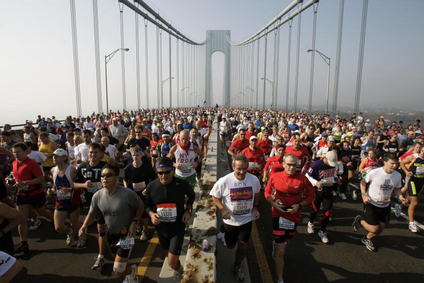 FILE - This is a Nov. 6, 2005, file photo showing runners on the upper level of the Verrazano Bridge at the start of the 36th New York City Marathon. The New York City Marathon scheduled for Nov. 1, 2020, has been cancelled because of the coronavirus pandemic. New York Road Runners announced the cancellation of the world's largest marathon Wednesday, June 24, 2020, after coordinating with the mayor's office and deciding the race posed too many health and safety concerns for runners, volunteers, spectators and others.(AP Photo/Richard Drew, File)