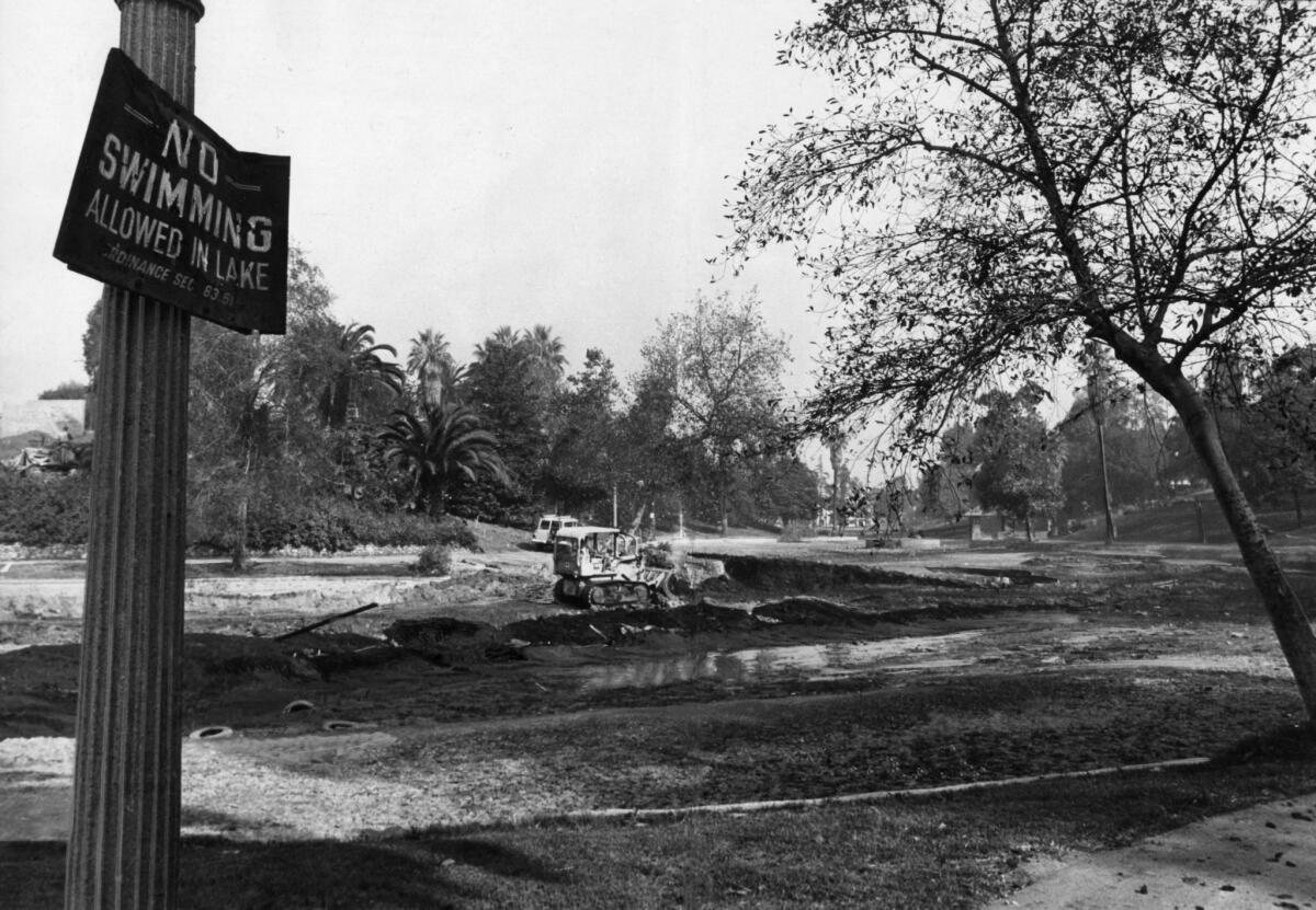 Nov. 18, 1970: Bulldozer removes dirt from Hollenbeck Lake bottom to make room for new pontoon bridge. The old bridge had been torn down a month earlier.