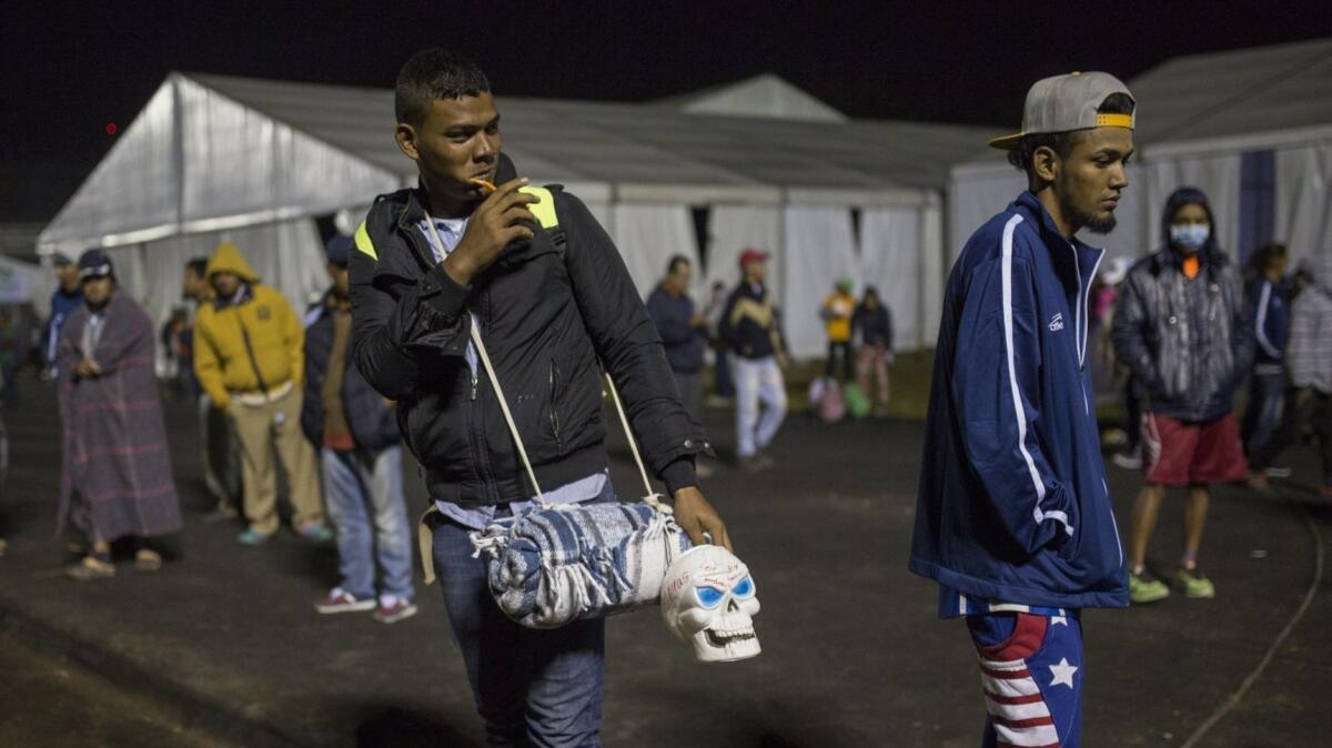 A Central American migrant prepares to leave the temporary shelter in the Jesus Martinez stadium in Mexico City on Friday. A group of 500 migrants decided to get ahead of the caravan and head north toward the city of Queretaro.