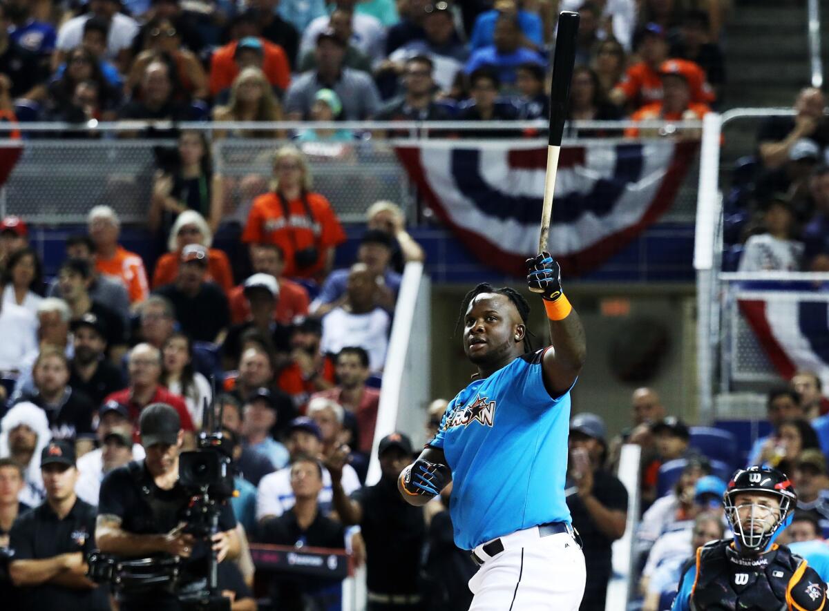 Miguel Sano admires one of his homers Monday night.