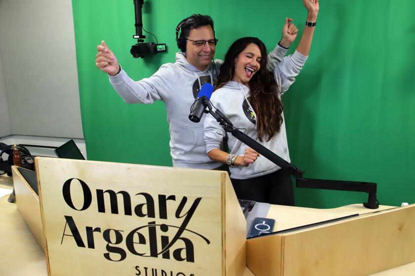Omar and Argelia dance together celebrating the first broadcast of their new online live show Omar y Argelia hosted by the husband-and-wife team of Omar Velasco and Argelia Atilano at the Omar y Argelia studios in Valley Village on Wednesday, May 15, 2024.
