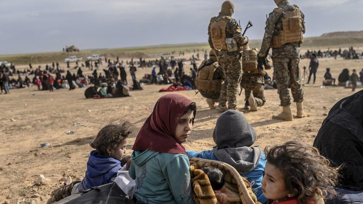 Civilians evacuated from the Islamic State group's embattled holdout of Baghouz wait at a screening area held by the U.S.-backed Kurdish-led Syrian Democratic Forces in the eastern Syrian province of Dair Alzour on March 5, 2019.