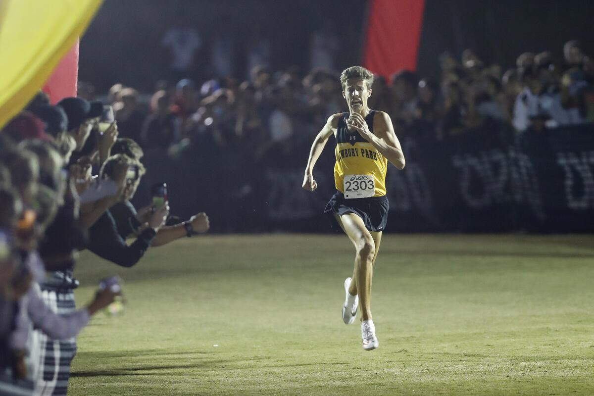 Newbury Park's Nico Young approaches the finish line in the Doug Speck's boys' sweepstakes race during the 39th annual Woodbridge Cross-Country Invitational on Saturday at SilverLakes Sports Park in Norco. Young finished with a time of 13:39.7.