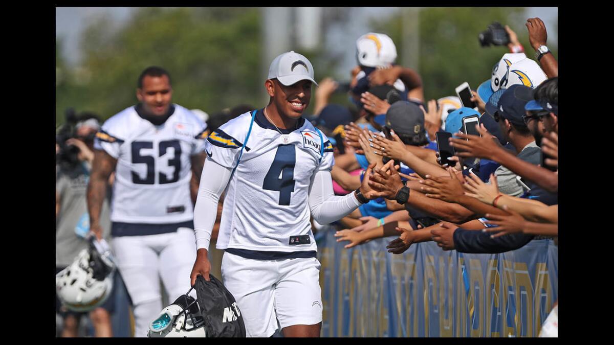 Chargers kicker Roberto Aguayo greets fans waiting before practice with the team at Jack Hammett Sports Complex in Costa Mesa on July 28.