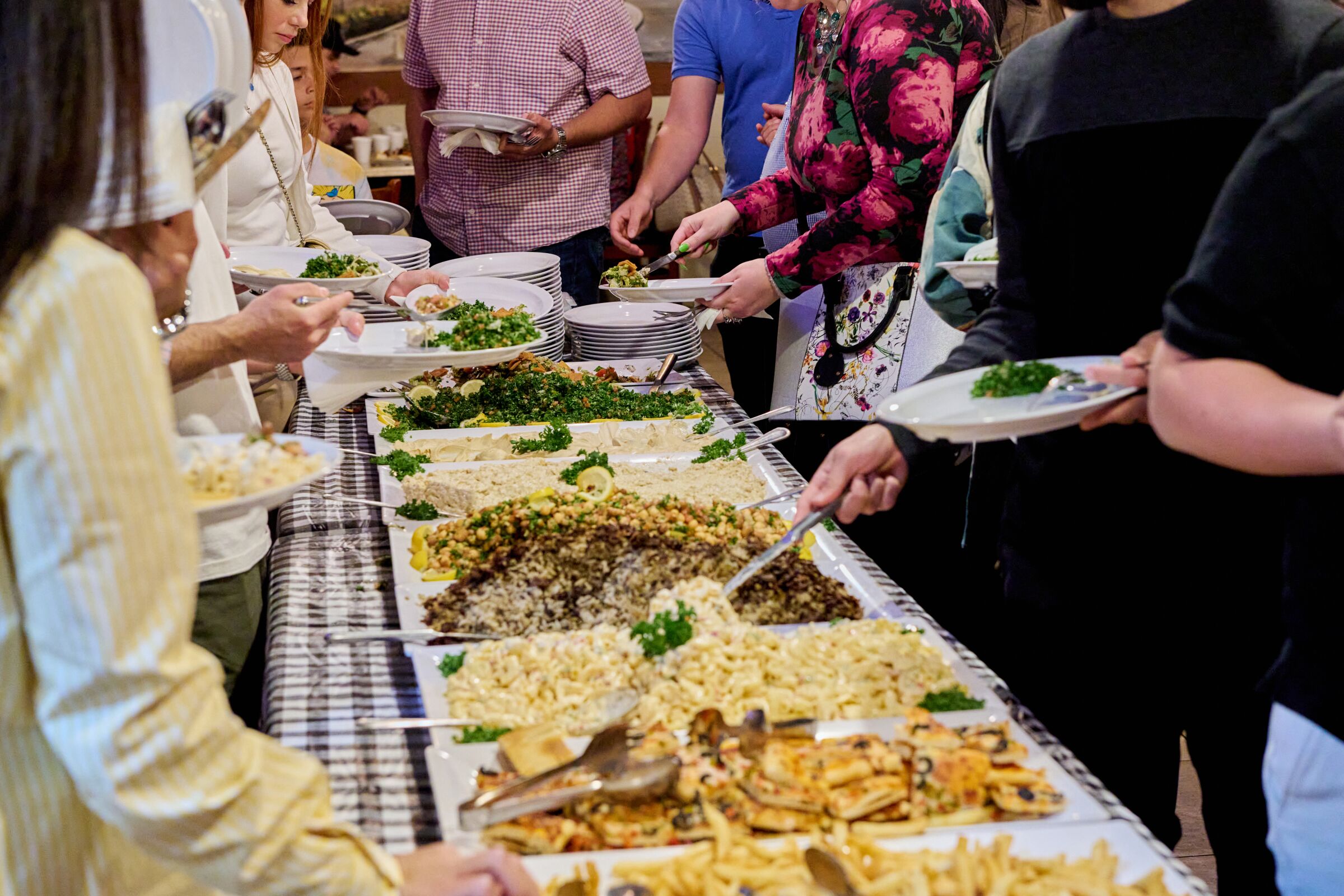 Diners line up to break their fast with an iftar buffet during Ramadan at Aleppo's Kitchen in Anaheim.